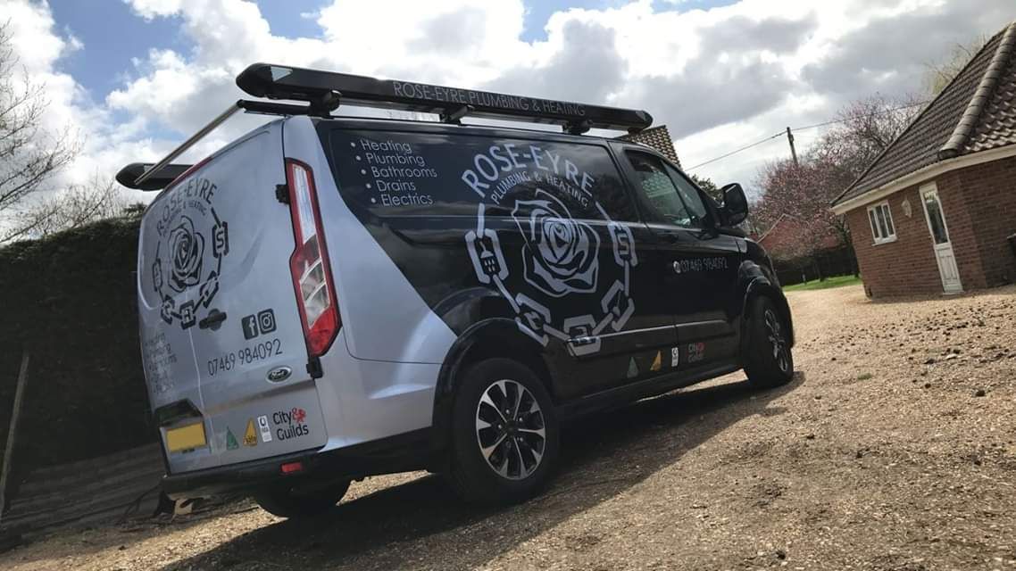 The Rose-Eyre Plumbing and Heating van with the rose logo and the list of services on the side